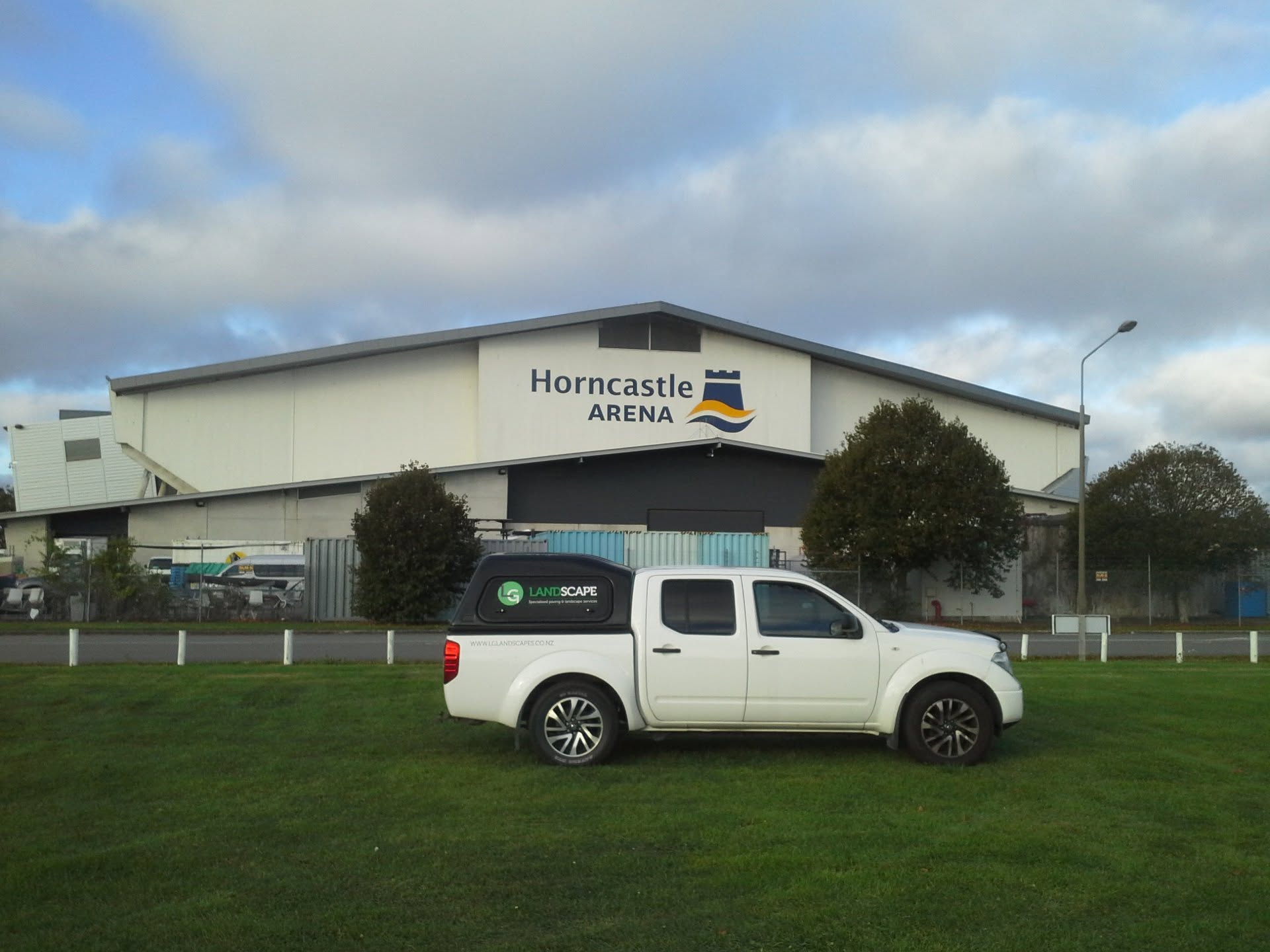 Branded LG Landscapes ute on a finished lawn, working across Canterbury